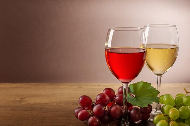 Composición de vino con copas de vino y uva.