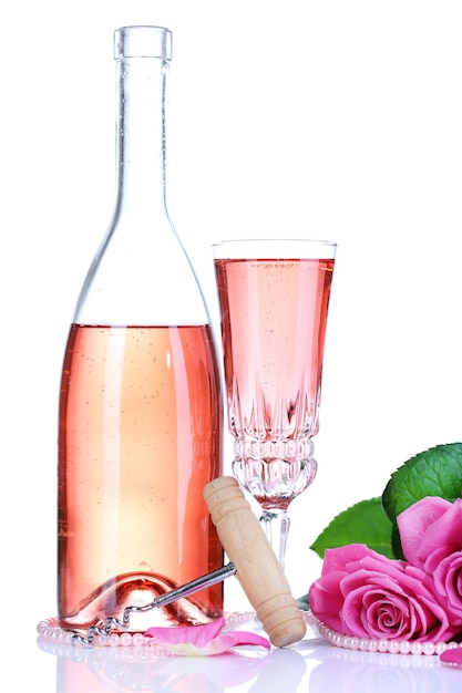 Composición con vino espumoso rosa en copa, botella y rosas rosadas aisladas en blanco