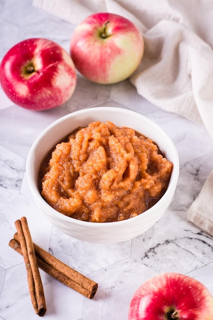 Compota de manzana casera en un bol y fruta fresca en la mesa Comida orgánica Vista vertical