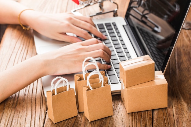 Compras en línea en el concepto de hogar. Cartones en un carrito de compras en un teclado portátil.