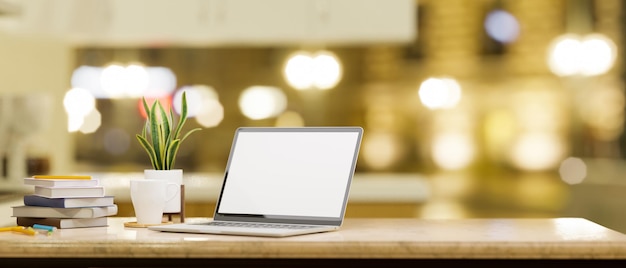 Computador laptop na mesa sobre a luz amarela desfocada do bokeh no fundo 3d render