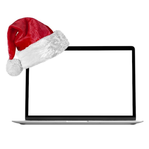 Foto computador portátil moderno com um chapéu de papai noel para o natal nos fundos brancos