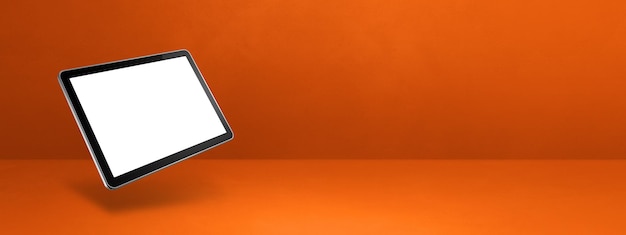 Computadora flotante tablet pc aislada sobre fondo de banner horizontal naranja