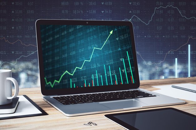 Computadora portátil en el escritorio con gráfico de acciones en suministros de pantalla y otros elementos en un fondo de análisis borroso Simulacro de renderizado 3D