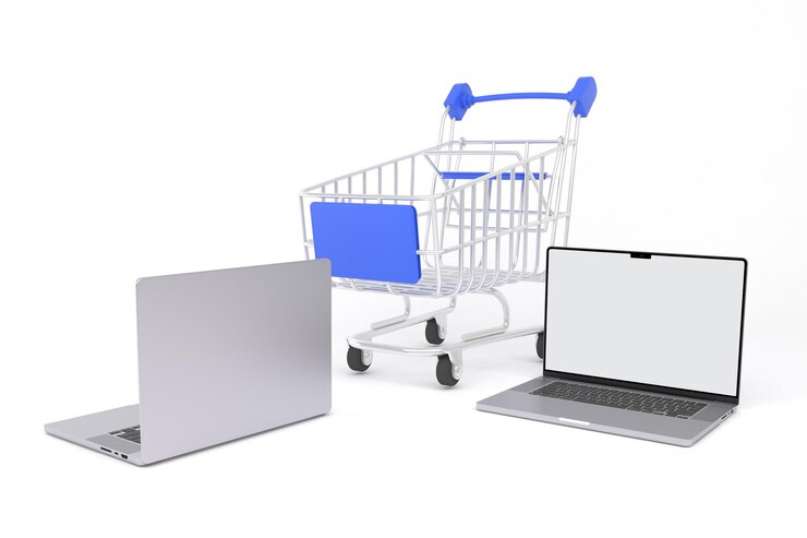 Foto computadoras portátiles y carrito de la compra lado derecho en fondo blanco.