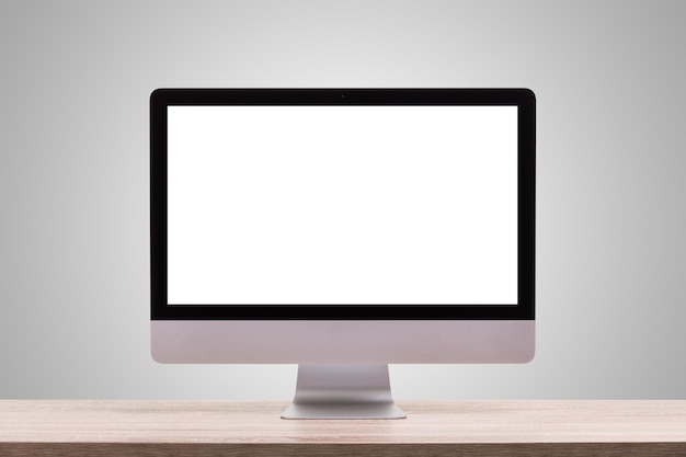 Computermonitor auf Tisch vor grauem Hintergrund