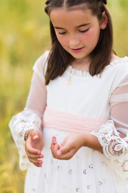 Comunión niña jugar con mariquita niño religión católica celebración hispana