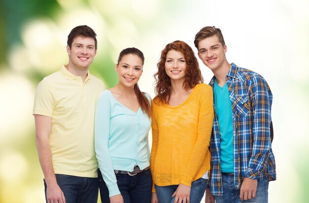 conceito de amizade, ecologia e pessoas - grupo de adolescentes sorridentes sobre fundo verde