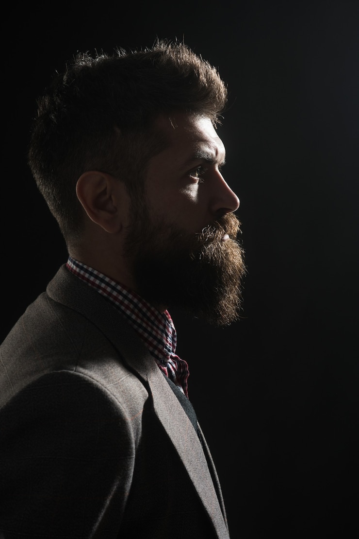 Foto conceito de barbearia de publicidade. silhueta de homem barbudo sério em estilo vintage. retrato clássico vintage masculino. moda vintage.