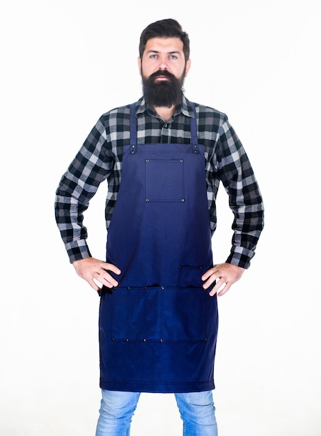 Conceito de barbearia estilo hipster Cabeleireiro salão de barbeiro para homens Hipster barbudo brutal com uniforme de avental de bigode Funcionários da barbearia Salão de preparação de barba Barbeiro macho bem preparado