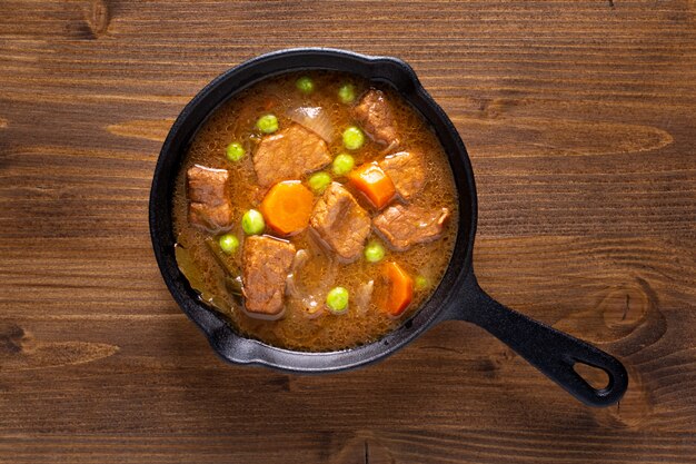 Conceito de comida de inverno caseiro ensopado orgânico ou bourguignon em frigideira de ferro fundido