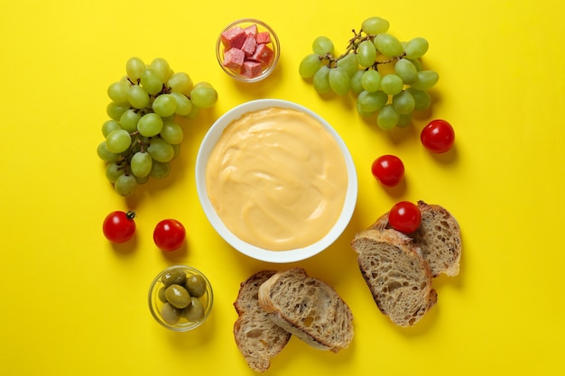 Conceito de comida deliciosa com fondue em fundo amarelo