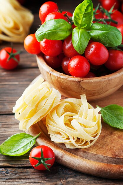 Conceito de comida italiana com manjericão, macarrão e tomate, foco seletivo