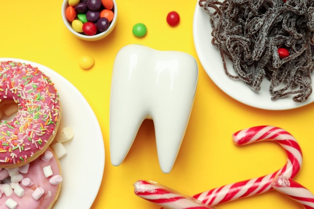 Conceito de comida ruim para os dentes em fundo amarelo