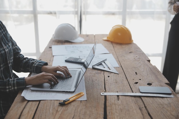 Conceito de construção e estrutura de desenho de trabalho de engenheiro na reunião de planta para projeto trabalhando com parceiro na construção de modelo e ferramentas de engenharia no conceito de construção do local de trabalho