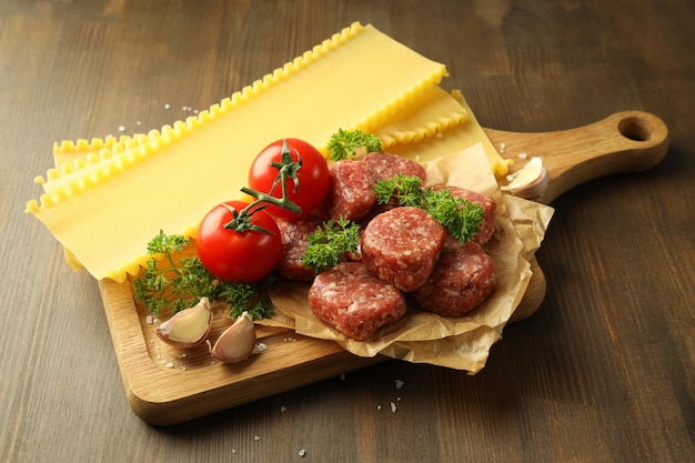 Conceito de cozinhar a composição de lasanha na mesa de madeira