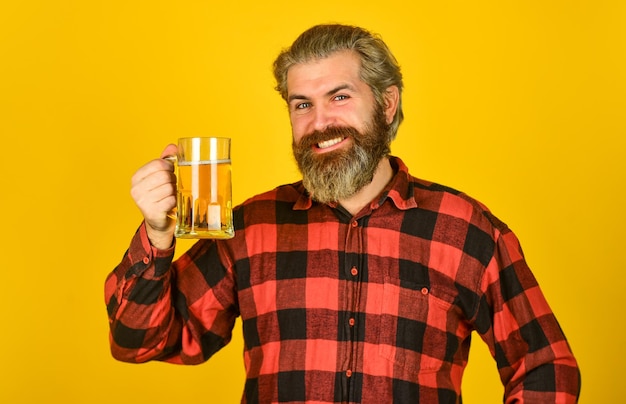 Foto conceito de feliz aniversário faça um gole comemore com álcool adicionando alegria na vida homem barbudo maduro segura copo de cerveja lazer e celebração homem bebendo cerveja no pub cervejaria cervejaria hipster bebe cerveja