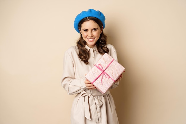 Conceito de feriados e presentes linda garota recebe caixa de presente e parece feliz segurando rosa embrulhado...