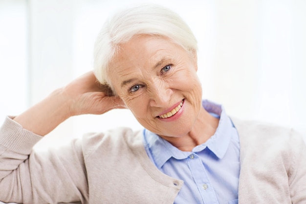 conceito de idade e pessoas - mulher sênior sorridente feliz em casa