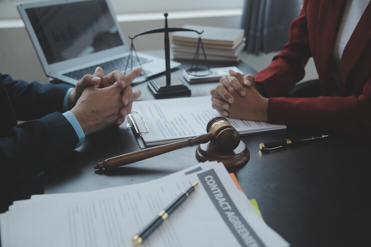 Foto conceito de justiça e direito juiz masculino em um tribunal com o martelo trabalhando com computador e óculos de teclado de encaixe na mesa na luz da manhã