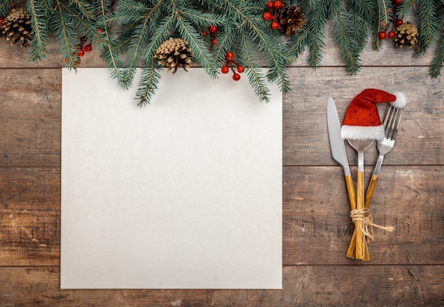 Conceito de menu de Natal com talheres decorados, galhos de árvores e bugigangas Decorações de Natal Talheres