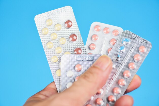 Conceito de métodos de contracepção / Mulher segurando pílulas contraceptivas contraceptivos de controle de natalidade significa prevenir a gravidez