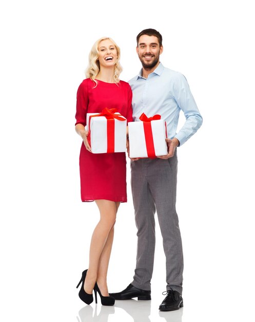 conceito de pessoas, natal, aniversário, casal e feriados - feliz jovem e mulher com caixas de presente