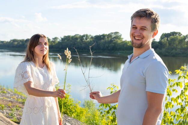 Conceito de piada, relacionamento e humor - Retrato de um casal apaixonado brincando na natureza