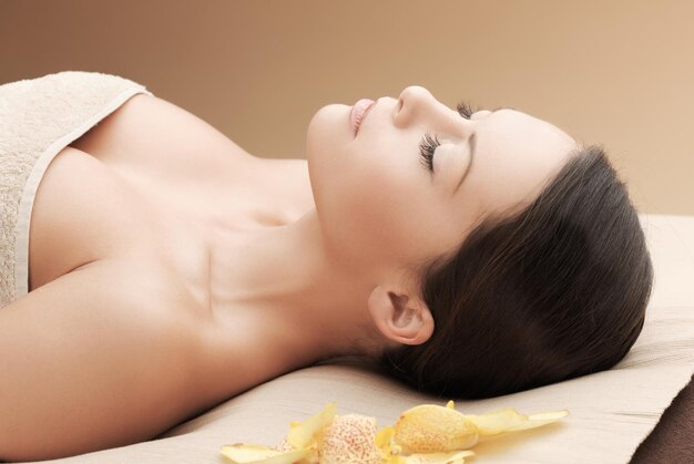 conceito de saúde e beleza, resort e relaxamento - mulher asiática no salão spa deitada na mesa de massagem