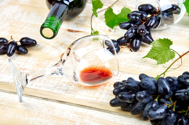 Conceito de vinho tinto com garrafa, copo e uvas