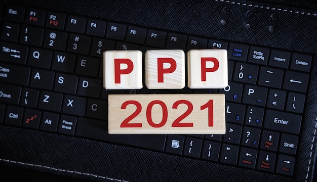 Conceito PPP 2021. Cubos de madeira em um teclado preto.