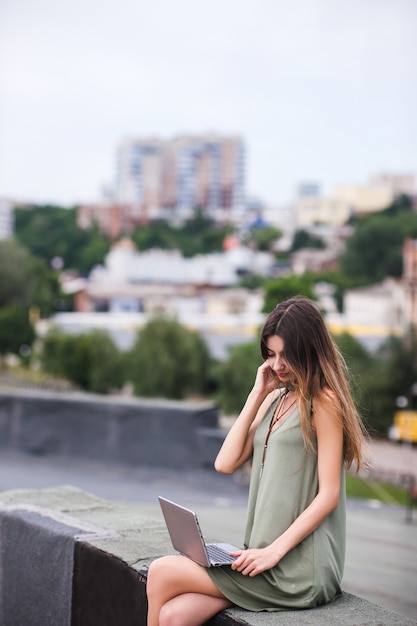 Conceito urbano do telhado da mulher ocupada do trabalho. Estilo de vida de freelancer. Combine negócios com prazer