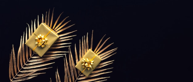 Foto conceitos de celebração com decoração de caixa de presente de ouro com folha simulada em fundo escuro.