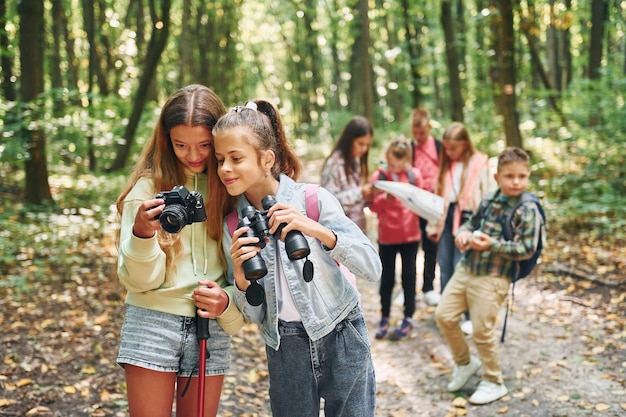 Concepción del turismo Niños en bosque verde durante el día de verano juntos