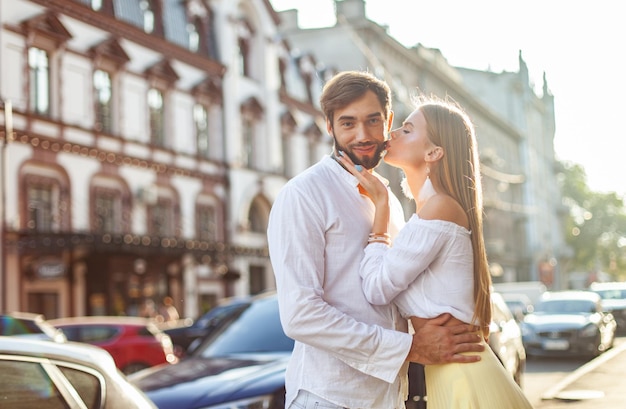 Foto concepto de amor romántico una pareja joven y enamorada se besan en la ciudad al atardecer