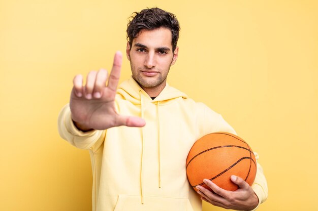 Concepto de baloncesto de hombre hispano guapo joven