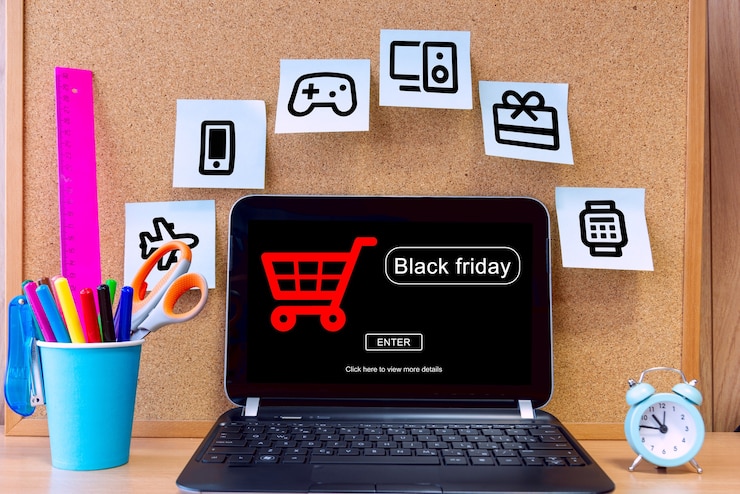 Foto el concepto de black friday. pantalla de portátil con letrero de texto black friday y pegatinas