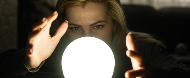 Foto concepto de ciencias ocultas. manos de mujer en una pelota para adivinar el futuro.