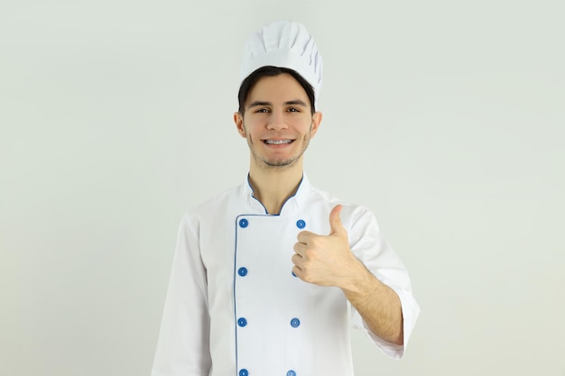 Concepto de cocinar joven chef masculino sobre fondo claro