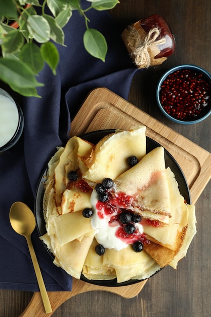 Concepto de comida sabrosa con crepes sobre fondo de madera