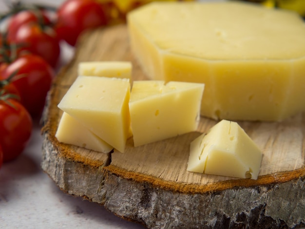 Concepto de comida sana casera: tomates cherry, rodajas de queso y aceite de oliva sobre fondo de hormigón claro