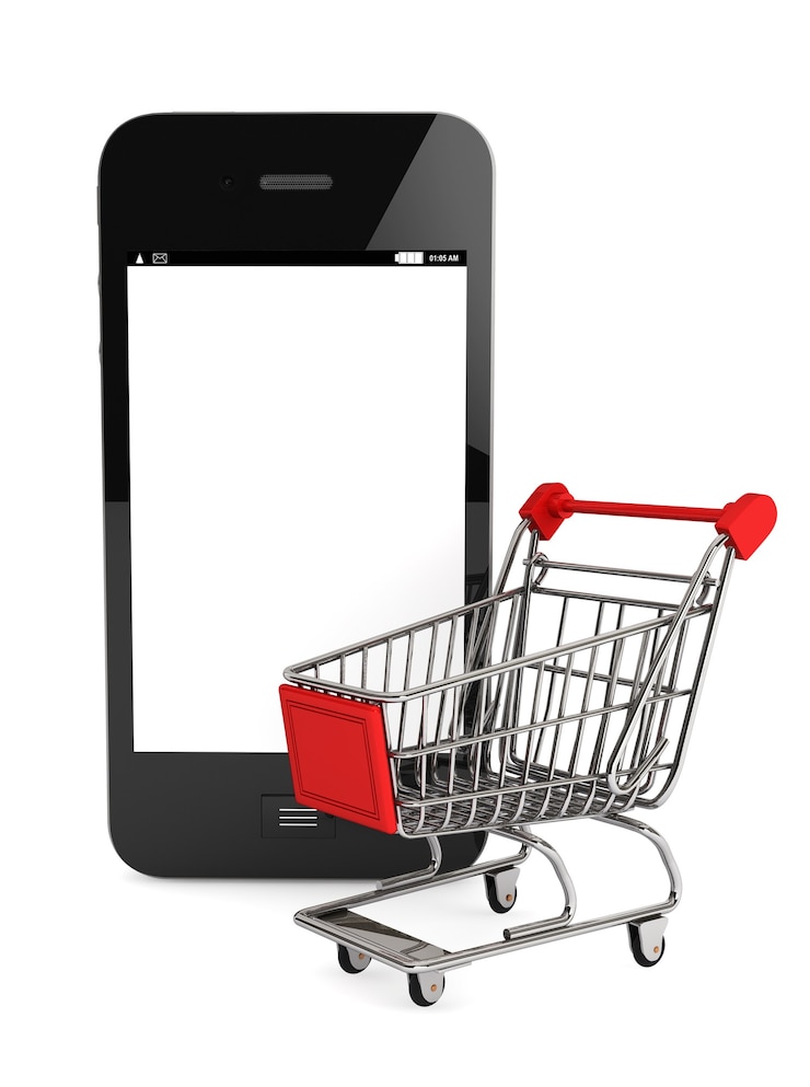Foto concepto de compra de smartphone. smartphone y un carrito de la compra sobre un fondo blanco.