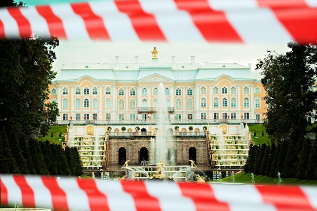 Foto concepto de cuarentena rusia san petersburgo palacio peterhof y gran fuente de cascada con cinta de advertencia