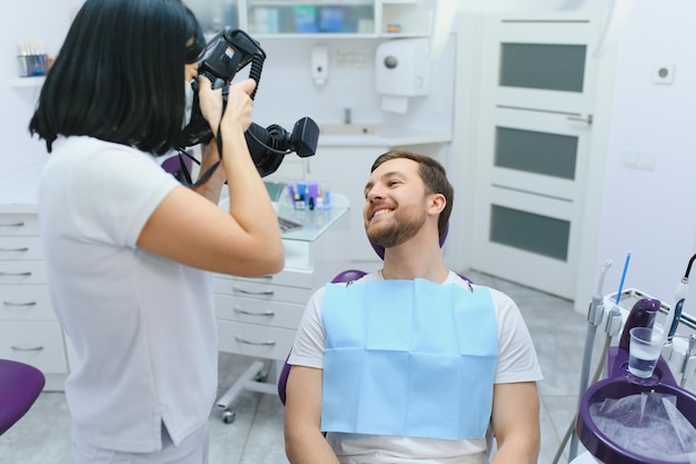 Concepto de cuidado dental Chico guapo joven en el consultorio del dentista