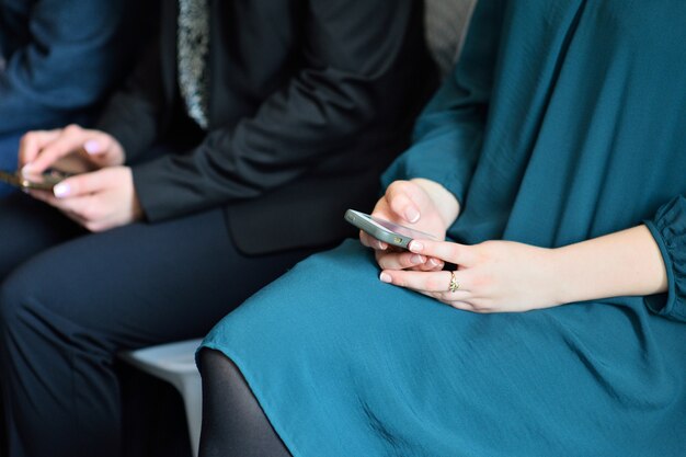 Concepto de dependencia telefónica. Mujer que sostiene el dispositivo y toca la pantalla o escribe un mensaje