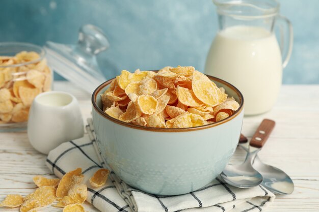 Concepto de desayuno con muesli y leche en la mesa de madera blanca