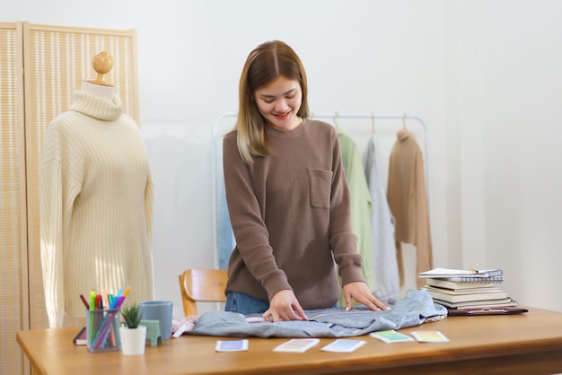 Concepto de diseño de moda Diseñador de moda que mide el tamaño de la camisa para verificar antes de enviar al cliente