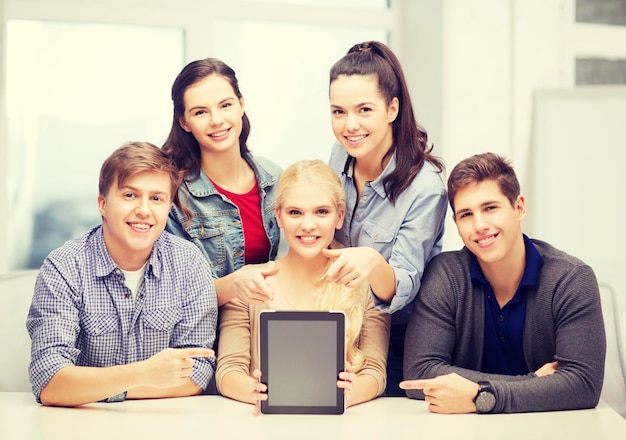 Concepto de educación, tecnología, publicidad e internet: grupo de estudiantes sonrientes con pantalla de tablet pc negra en blanco