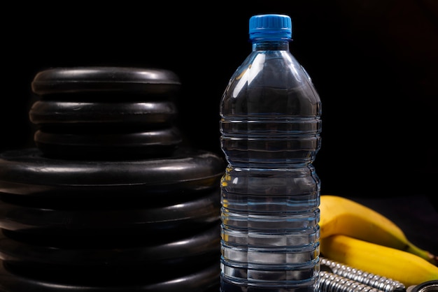 Concepto de estilo de vida saludable. Fitness, equipamiento deportivo, estilo de vida saludable y activo. Botella de agua, plátano, equipo.