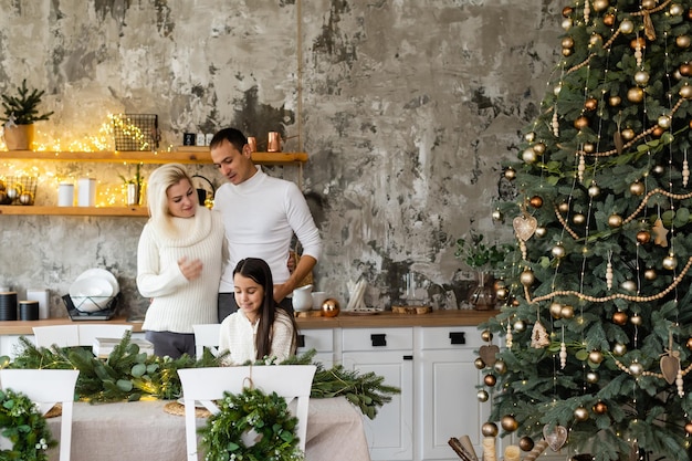 concepto de familia, navidad, navidad, invierno, felicidad y personas - familia sonriente Preparándose para celebrar la Navidad.